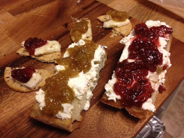 Toasted ciabatta with cream cheese and homemade green and black fig jam. On the left is a cracker with brie variation.